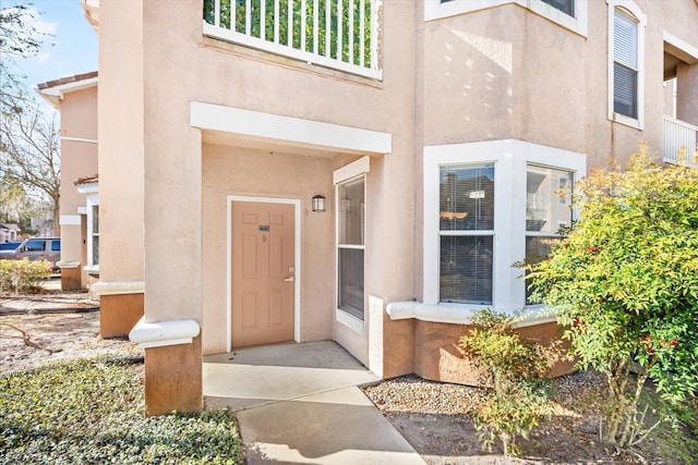 property entrance with stucco siding