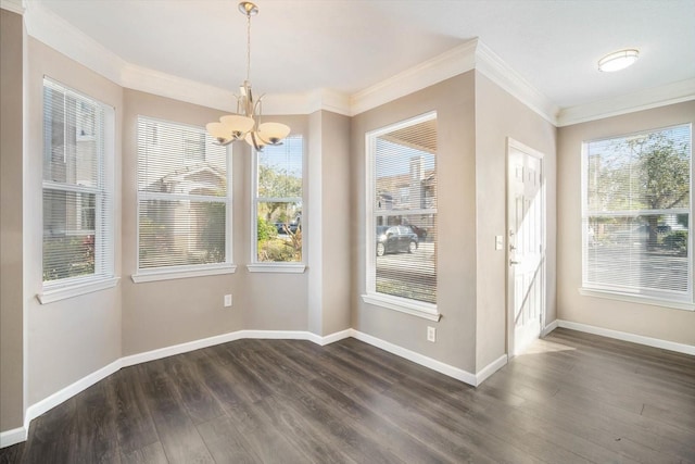 unfurnished dining area with a chandelier, crown molding, dark wood-style flooring, and baseboards