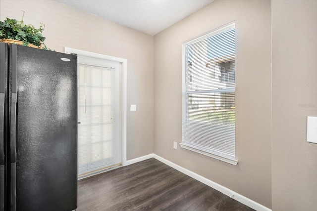 doorway to outside featuring dark wood finished floors and baseboards