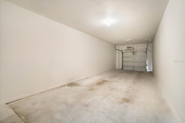 garage with a garage door opener and baseboards