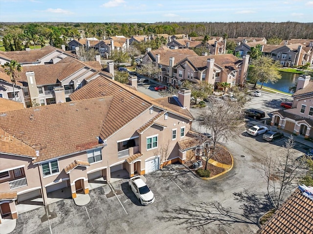 birds eye view of property with a water view and a residential view