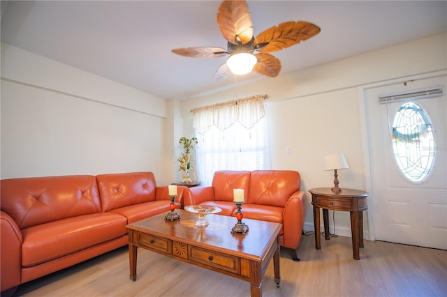 living room with light wood-style floors and a ceiling fan