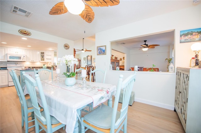 dining space featuring light wood-style flooring, recessed lighting, visible vents, baseboards, and a ceiling fan