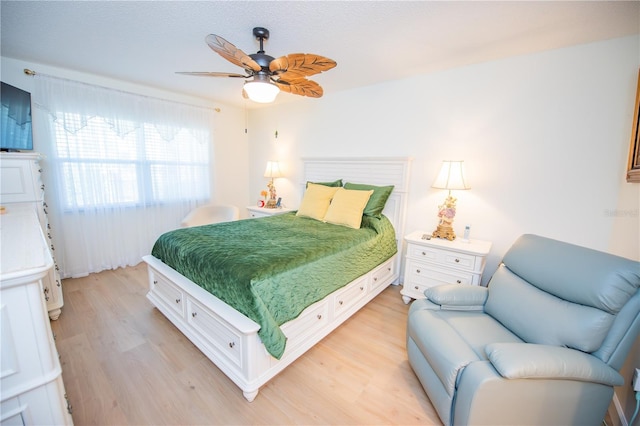 bedroom featuring light wood-style floors and ceiling fan