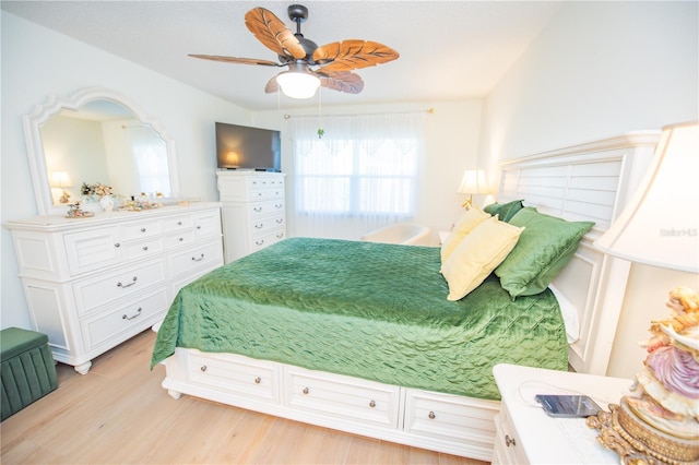 bedroom with light wood finished floors and a ceiling fan