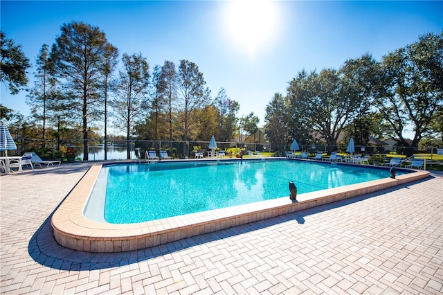 community pool featuring a patio and fence