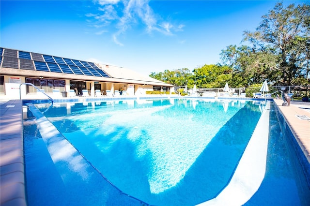 pool with fence and a patio