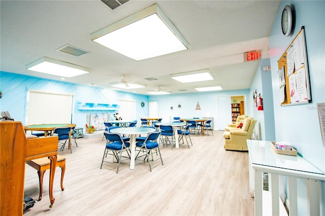 dining room featuring visible vents, ceiling fan, and light wood finished floors