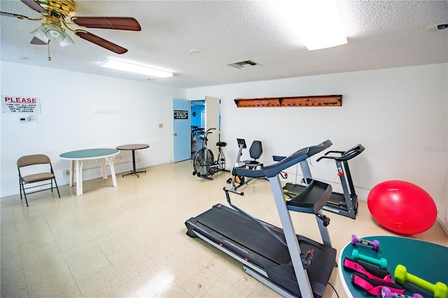 exercise area with a textured ceiling, a ceiling fan, visible vents, and tile patterned floors