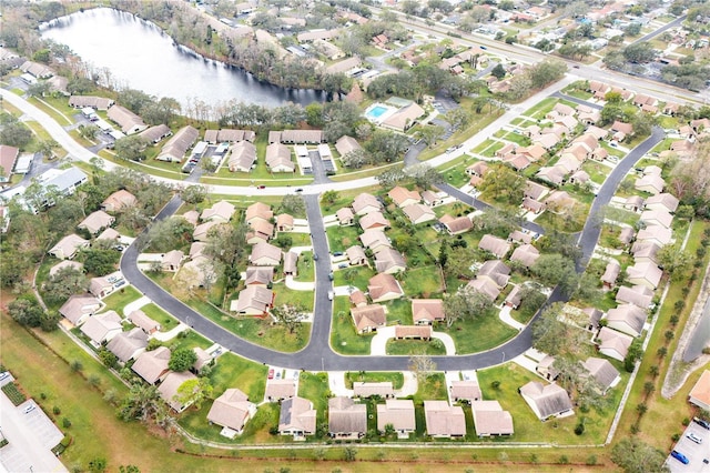 drone / aerial view with a water view and a residential view