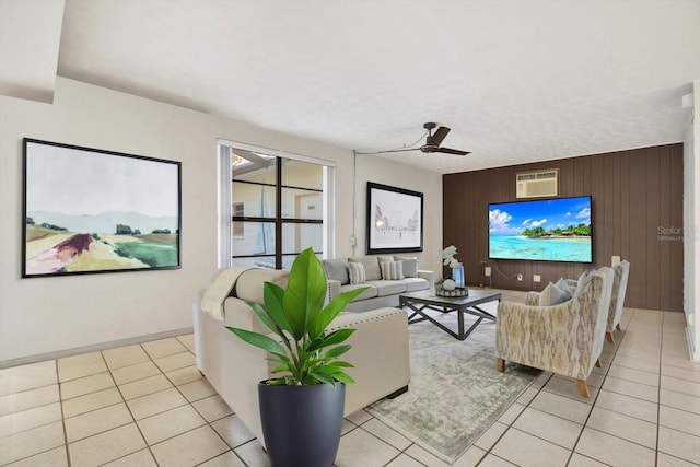 living area featuring wood walls, a ceiling fan, and light tile patterned flooring