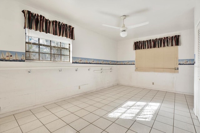 empty room featuring light tile patterned floors and ceiling fan