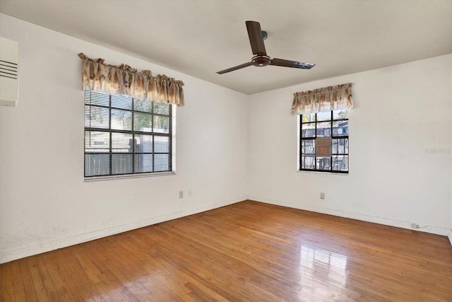 unfurnished room with baseboards, a ceiling fan, and wood finished floors