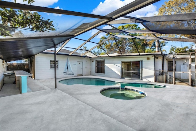 view of pool featuring a lanai, a patio area, and a pool with connected hot tub