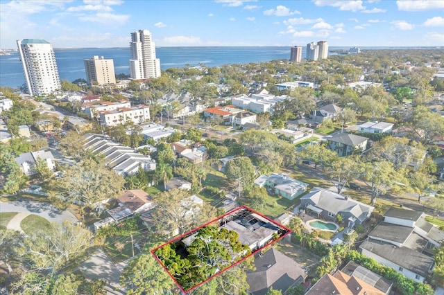 birds eye view of property with a view of city and a water view