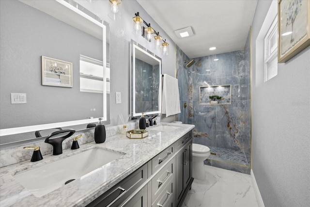 bathroom featuring a marble finish shower, marble finish floor, a sink, and toilet