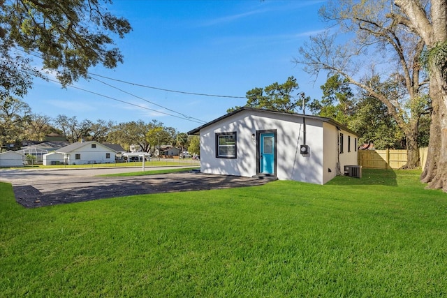 view of yard with fence and central AC