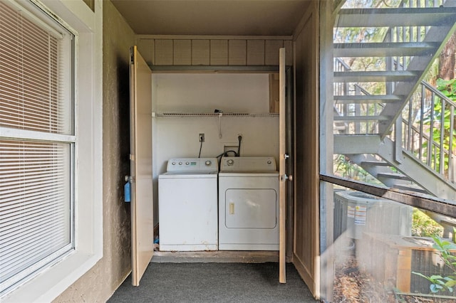 clothes washing area featuring laundry area and washer and clothes dryer