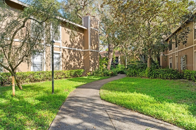 view of home's community featuring a lawn