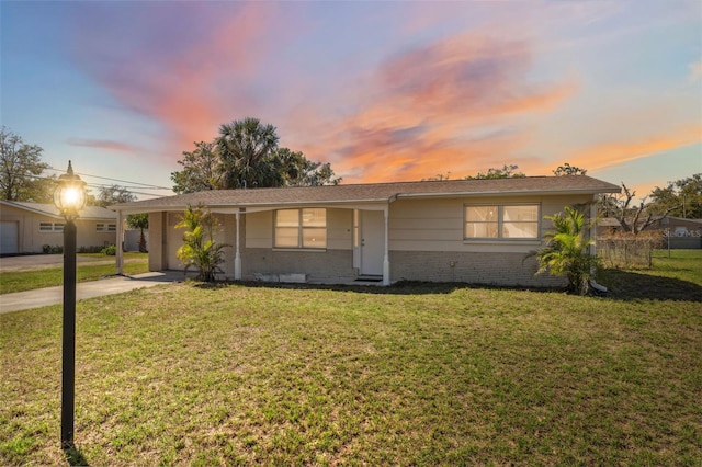 single story home with a front yard and brick siding