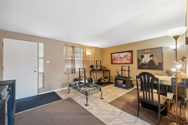 exercise room featuring baseboards and tile patterned floors