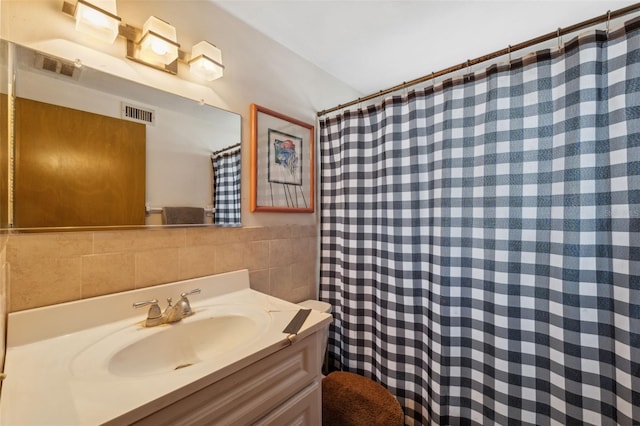 full bath with tile walls, visible vents, vanity, and curtained shower