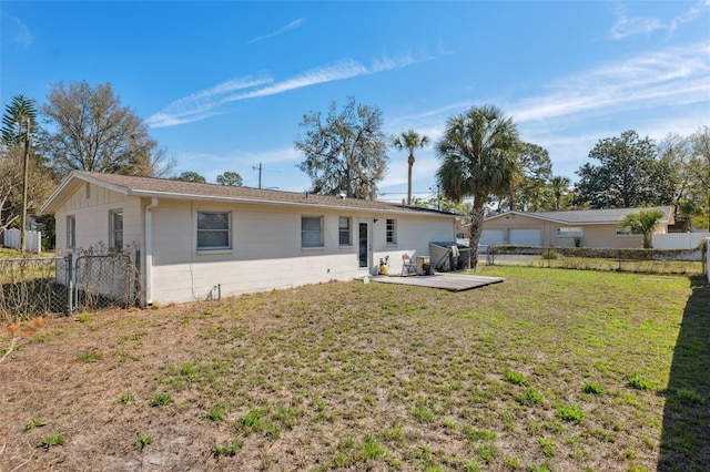 back of house with a yard, a patio, and fence