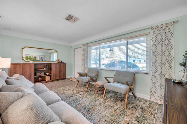 living room with visible vents and baseboards