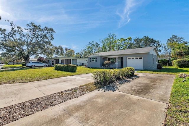 ranch-style home featuring an attached garage, driveway, and a front yard