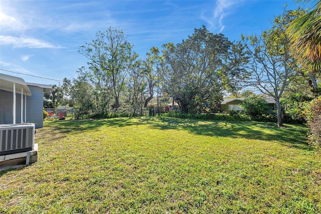 view of yard with cooling unit and fence