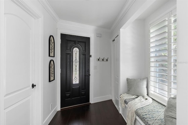 foyer with dark wood-type flooring, plenty of natural light, crown molding, and baseboards