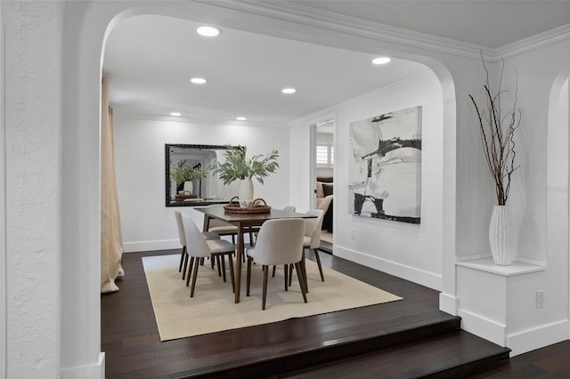 dining area with ornamental molding, dark wood-style flooring, and baseboards