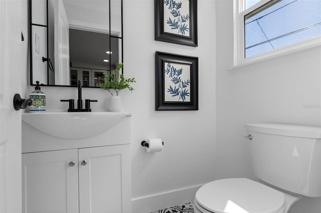 bathroom with toilet and vanity