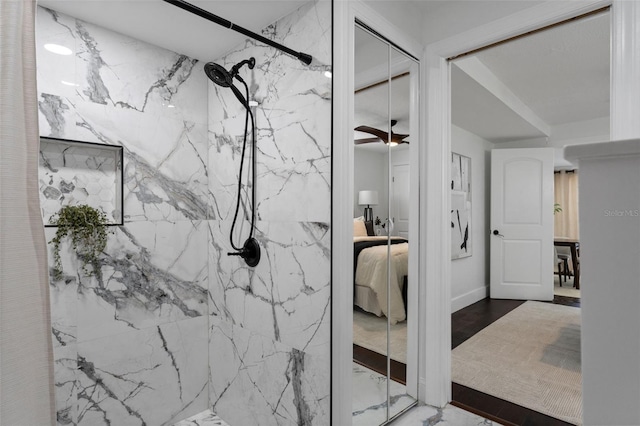 ensuite bathroom with marble finish floor, ensuite bath, and a marble finish shower