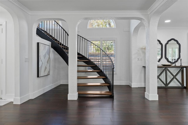 stairs with ornamental molding, baseboards, and wood finished floors