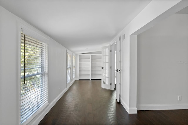 hall featuring baseboards and wood finished floors