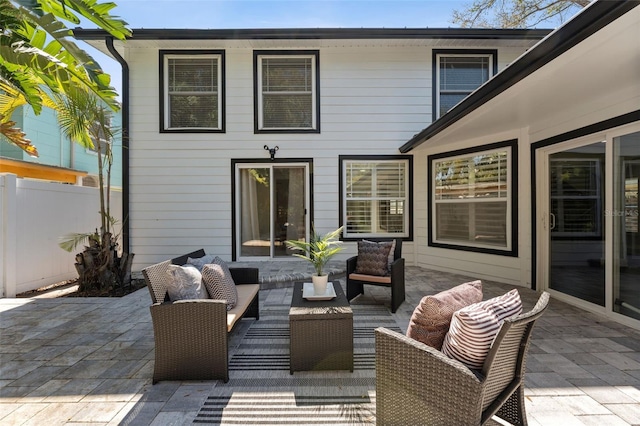 view of patio featuring fence and an outdoor hangout area