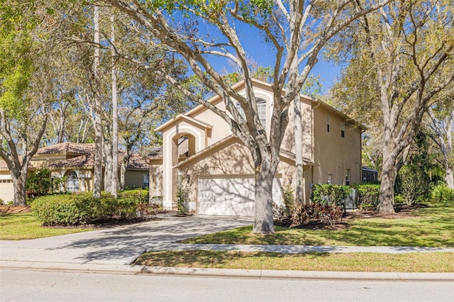 view of front of house with a garage, a front yard, driveway, and stucco siding