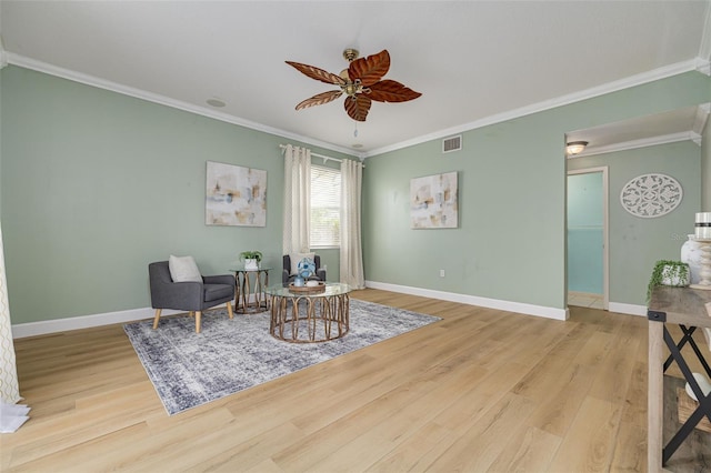 sitting room featuring a ceiling fan, visible vents, baseboards, and wood finished floors