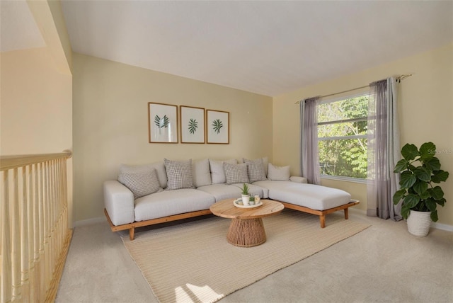 living room featuring baseboards and light colored carpet