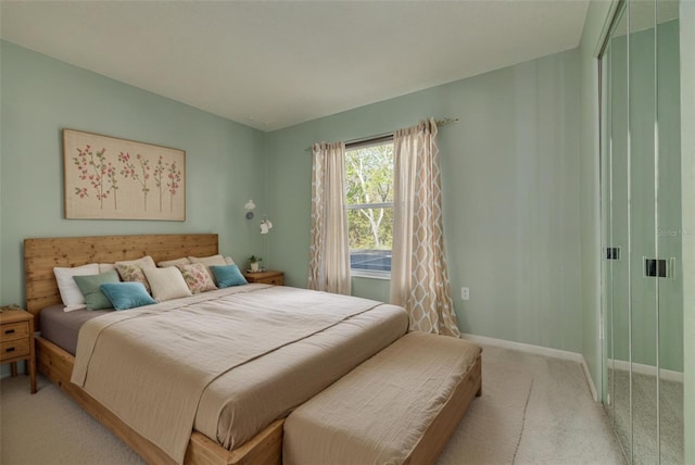 bedroom with light carpet and baseboards