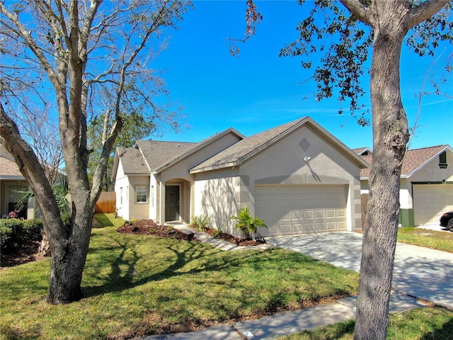 ranch-style house featuring an attached garage, a front yard, concrete driveway, and stucco siding