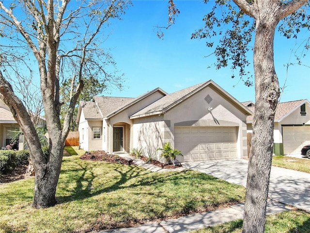 ranch-style home featuring a garage, driveway, a front yard, and stucco siding