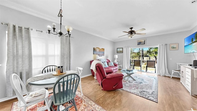 dining room with baseboards, light wood-style flooring, and crown molding