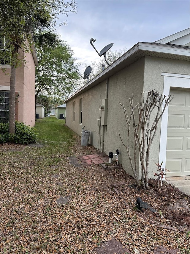 view of home's exterior with a garage and stucco siding