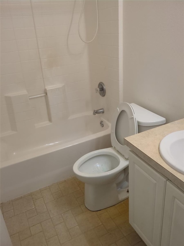bathroom with bathtub / shower combination, vanity, and toilet