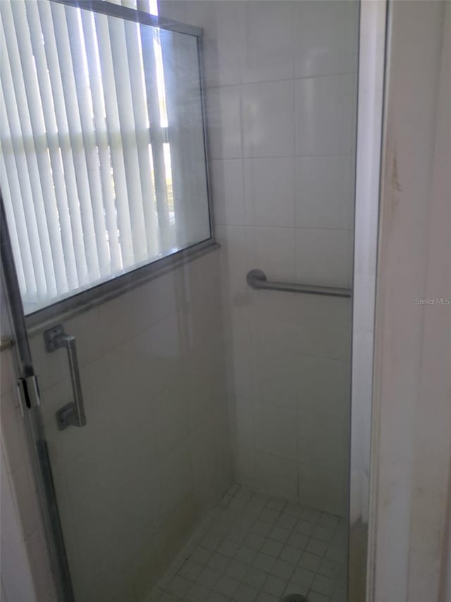 full bath with a shower stall