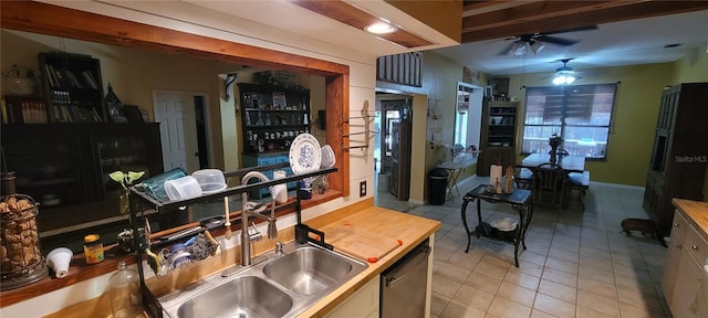 kitchen featuring stainless steel dishwasher, light tile patterned flooring, ceiling fan, and a sink