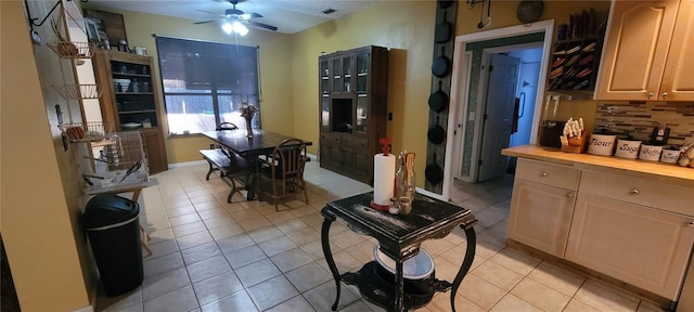 dining space featuring light tile patterned flooring, baseboards, and a ceiling fan