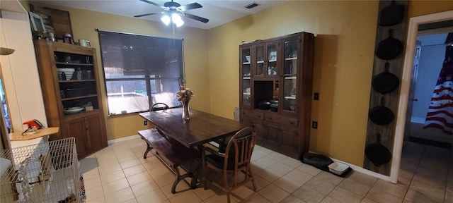 dining area featuring light tile patterned flooring, a ceiling fan, visible vents, and baseboards